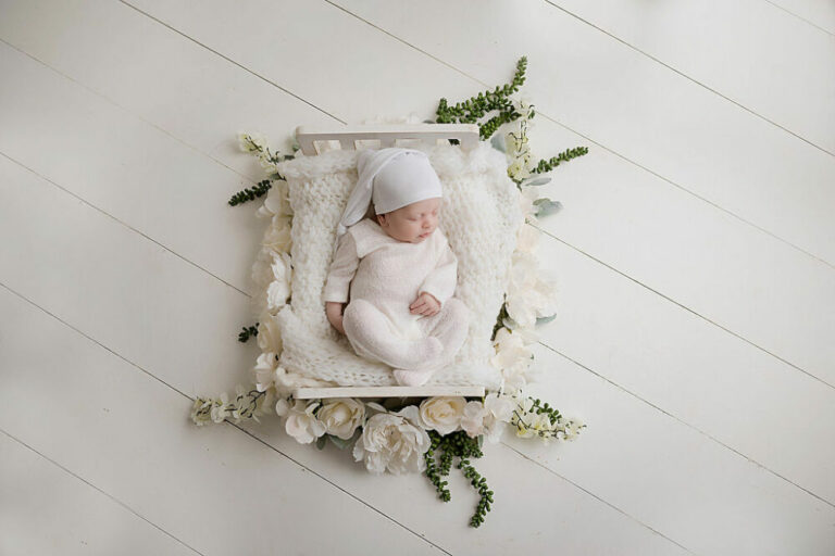 Newborn girl sleeping on baby photography props for navy blue maternity and newborn session in Mount Laurel, New Jersey