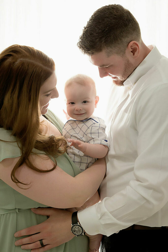 Mom and dad with baby boy for an in-studio family session in Southampton, New Jerysey.