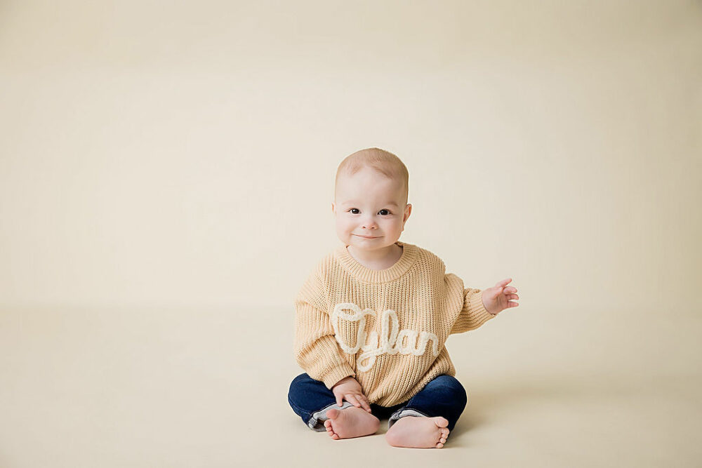 Smiling baby boy looking at camera for an in-studio family session in Mount Holly, New Jersey.