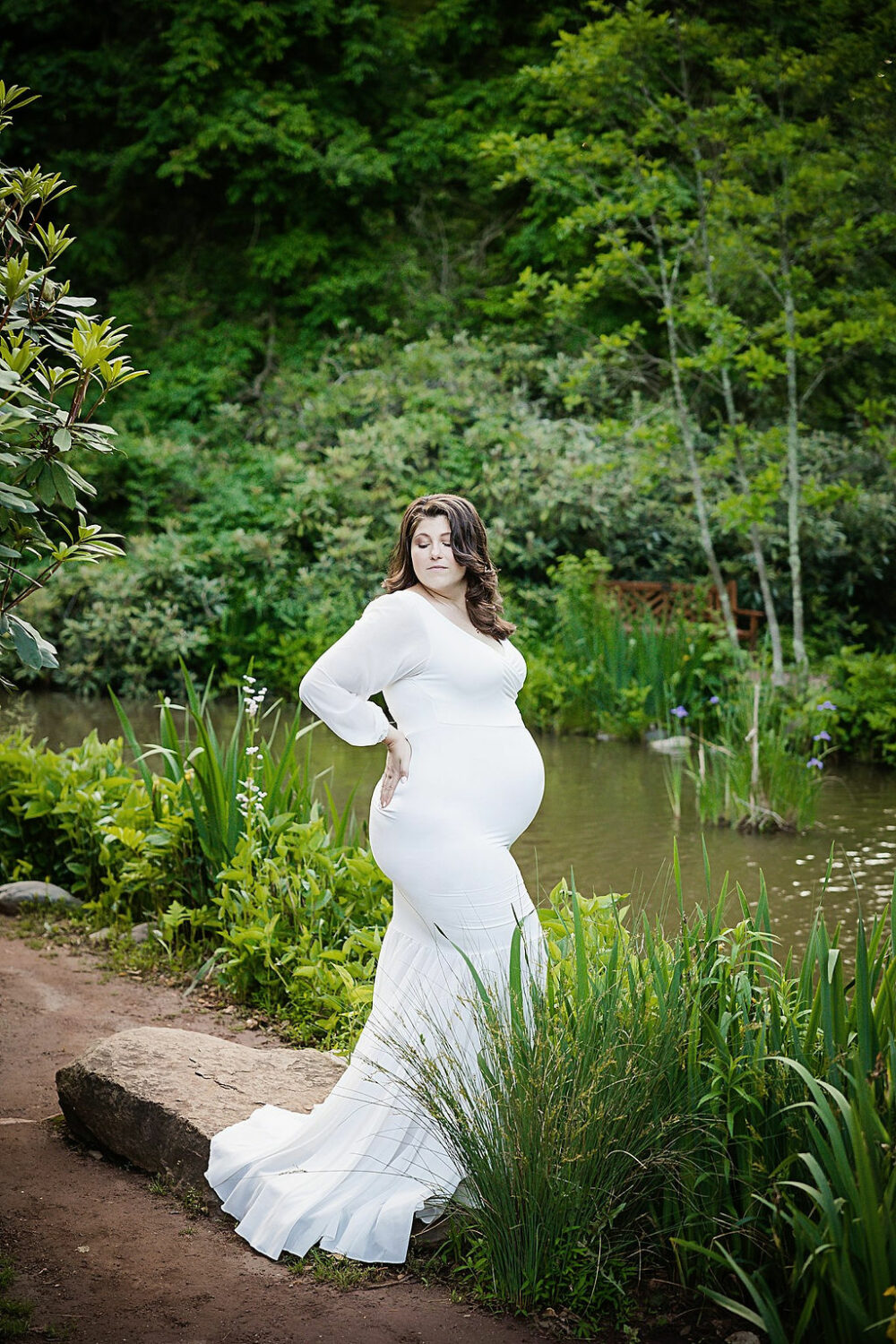 Pregnant women wearing long sleeve maternity dress for her professional pregnancy pictures taken in a garden in Vincentown, New Jersey.