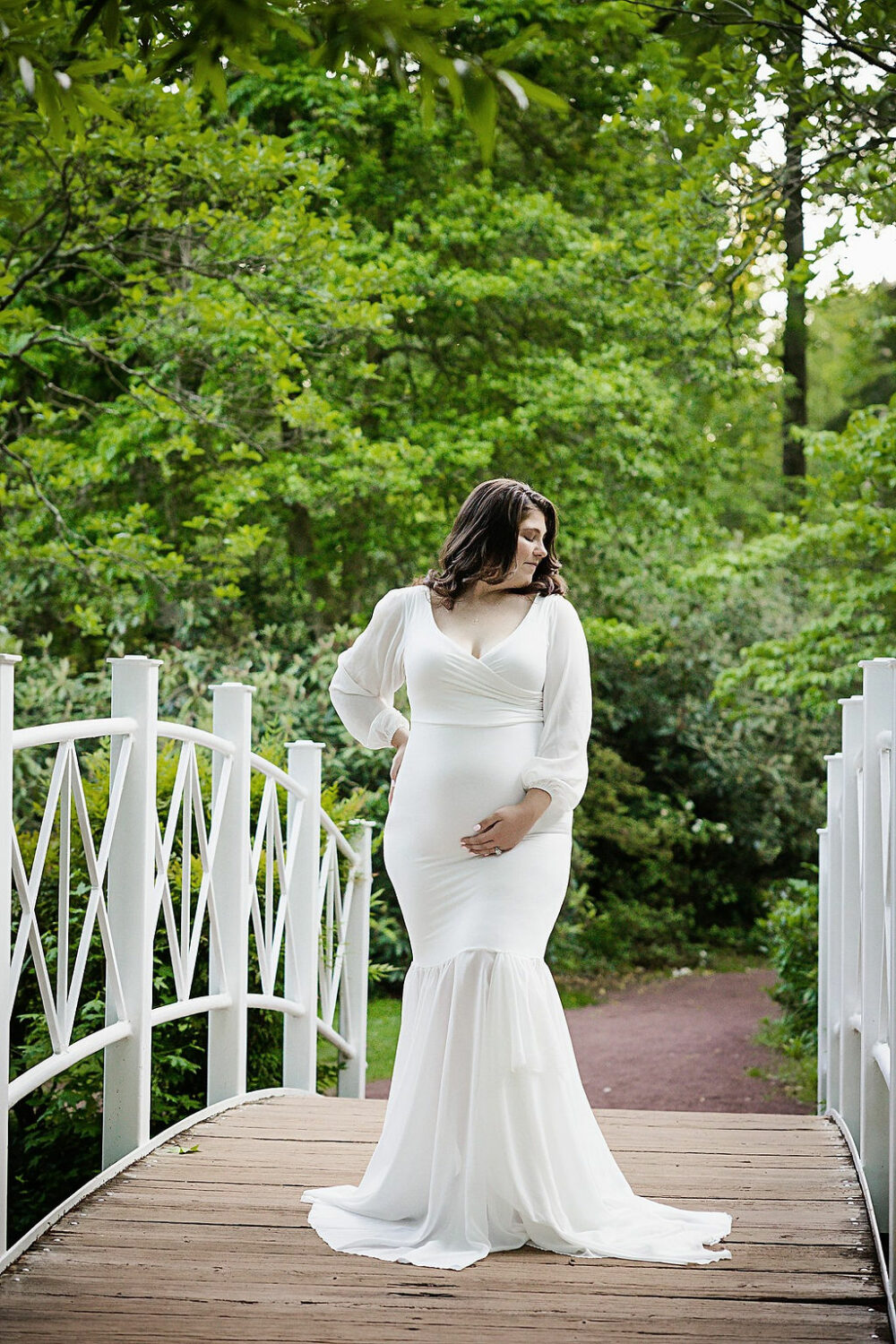 Pregnant women wearing tight maternity dress for her spring garden maternity session in Wrightstown, NJ.