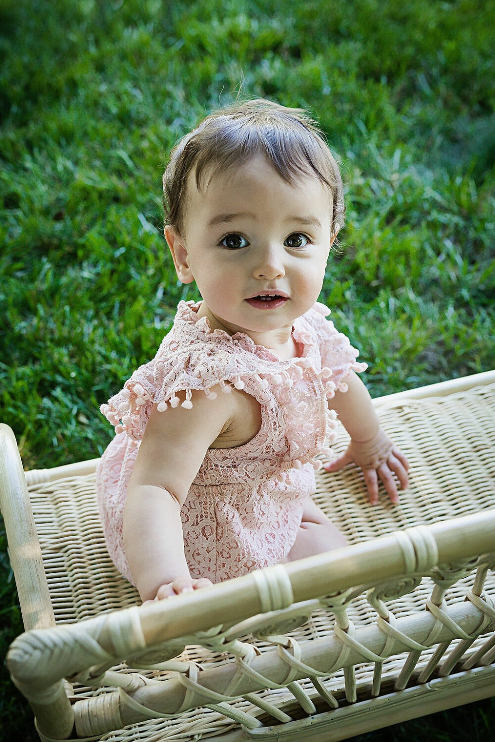 Close up of toddler girl on chair for her professional, baby portraits taken in Newark, New Jersey.