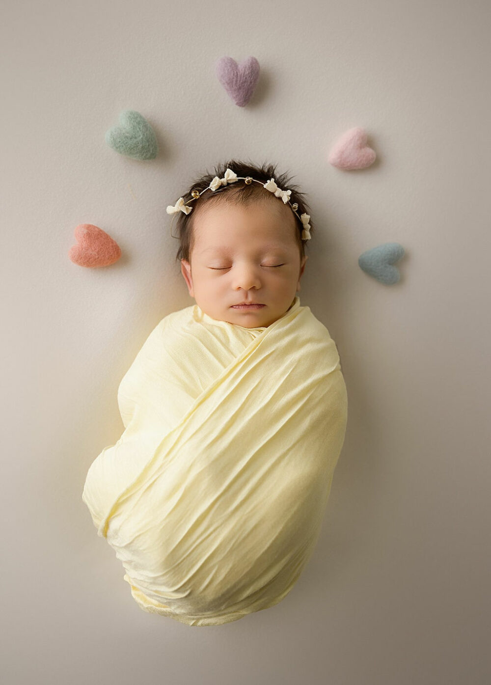 Close up of newborn girl, wrapped in swaddle, sleeping for her newborn, baby images taken in Trenton, New Jersey.