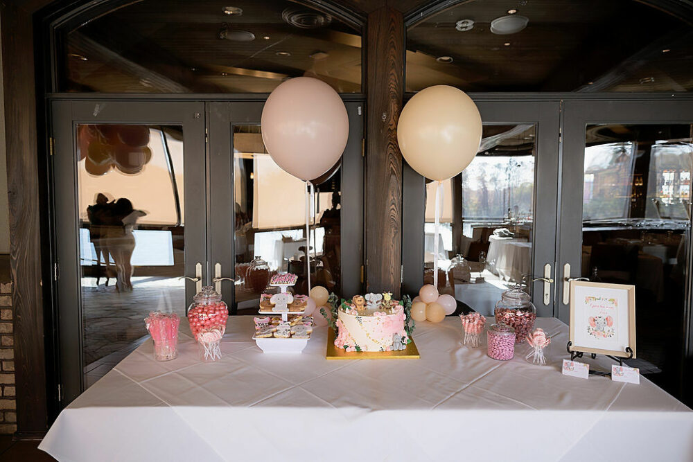 Table with balloons and snacks with cake in the middle taken for baby shower event in South Philadelphia