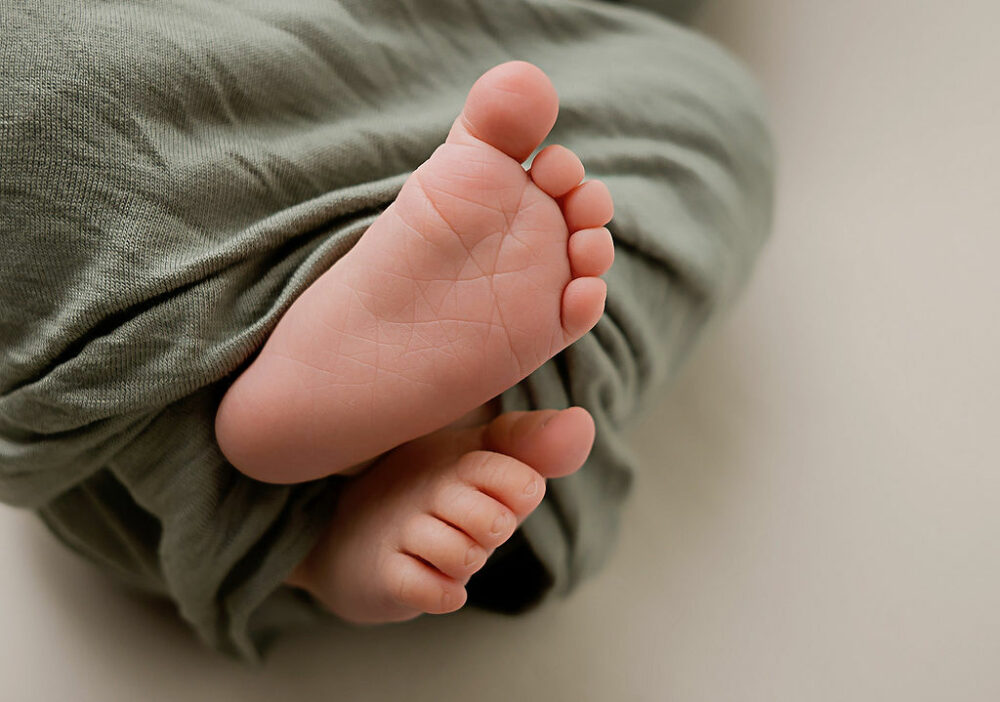 Close-up of a newborn baby feet taken for babies first newborn photos taken in studio in Burlington, New Jersey.