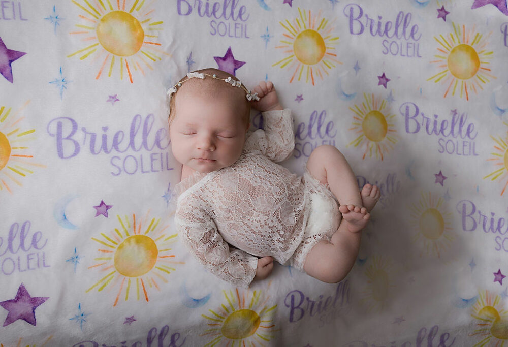 Newborn sleeping on personalized blanket with her name on it for her newborn photography session in Medford, New Jersey.