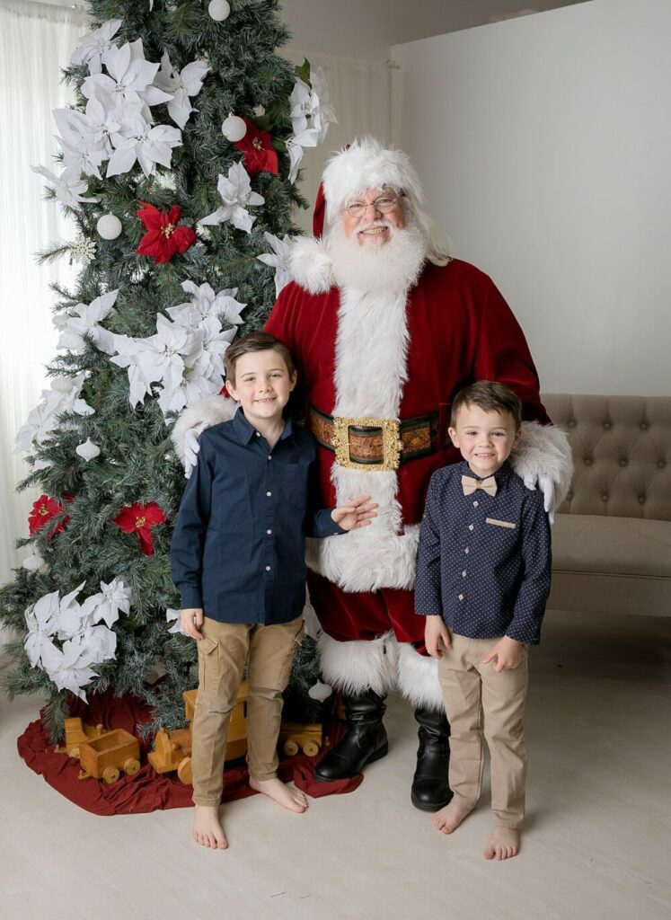 Kids smiling with Santa for photos in south jersey santa mini session