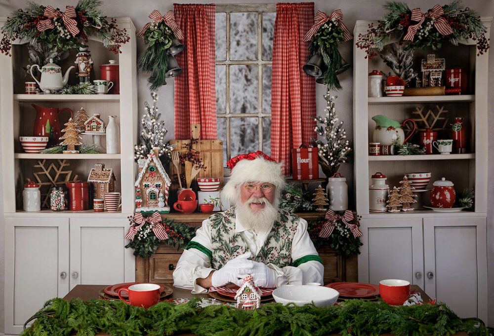 Santa sitting in photography Christmas set posing for santa mini session in Pemberton, New Jersey.