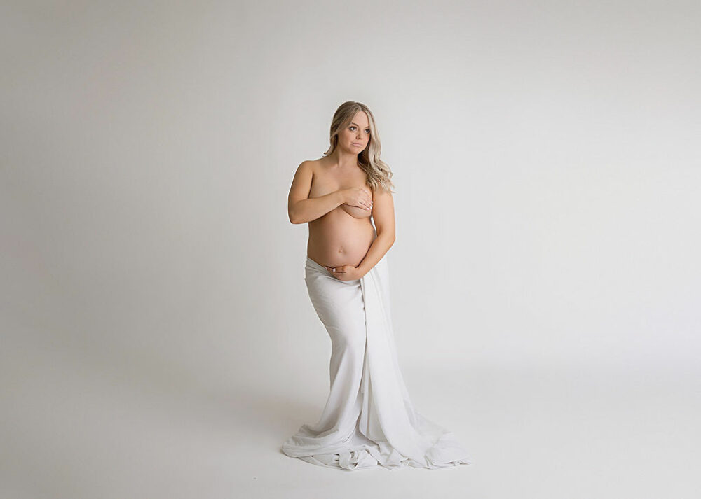 A beautiful portrait of a woman wearing a skirt and is posing for her professional pregnancy photos taken in Cherry Hill, New Jersey.