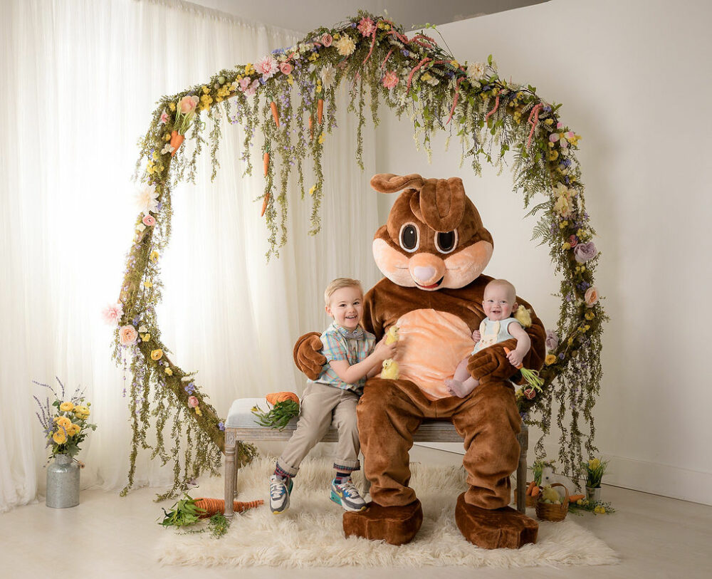 A toddler boy and a toddler girl sitting with the Easter bunny for their Easter bunny mini session in Southampton, New Jersey.