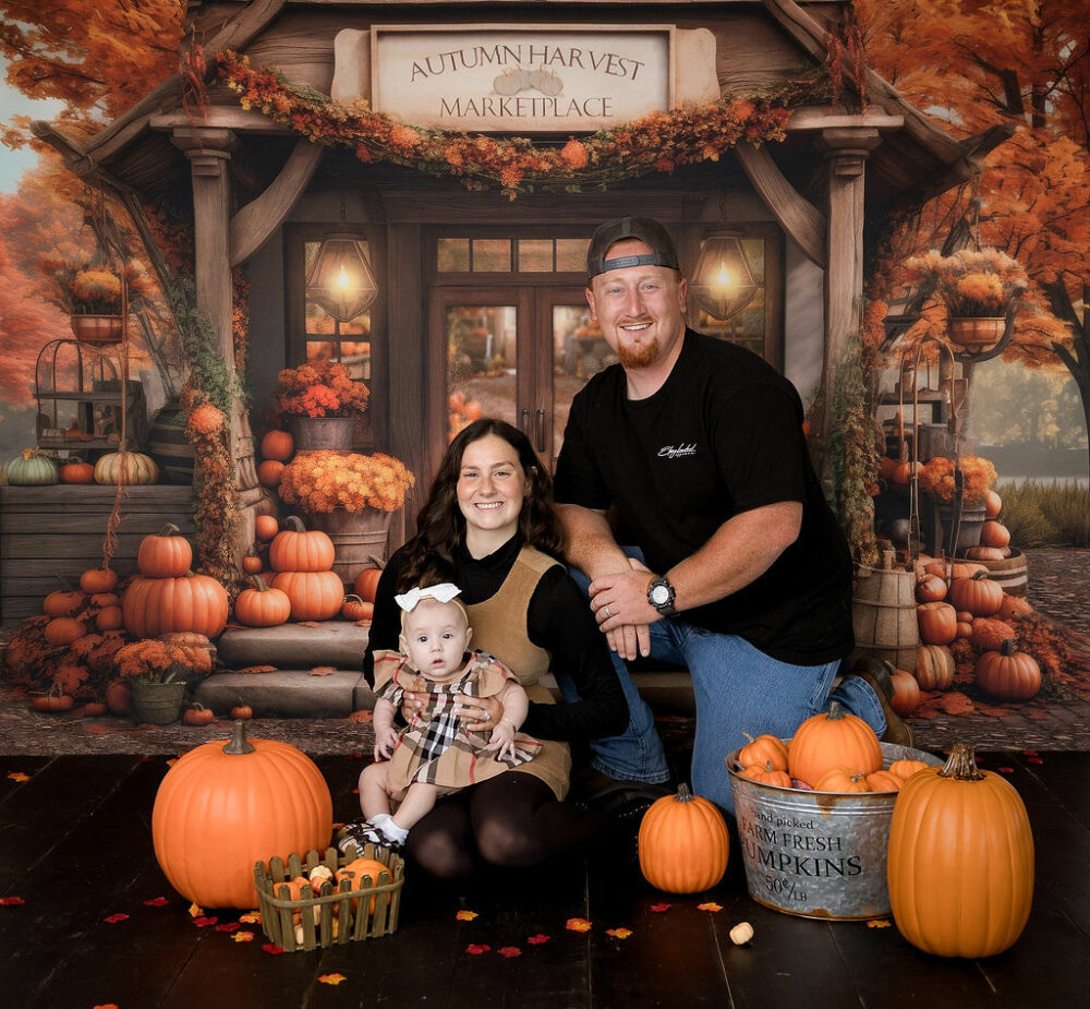 A family portrait of a man and woman sitting and posing for a fall in-studio mini session in Eastampton, New Jersey.